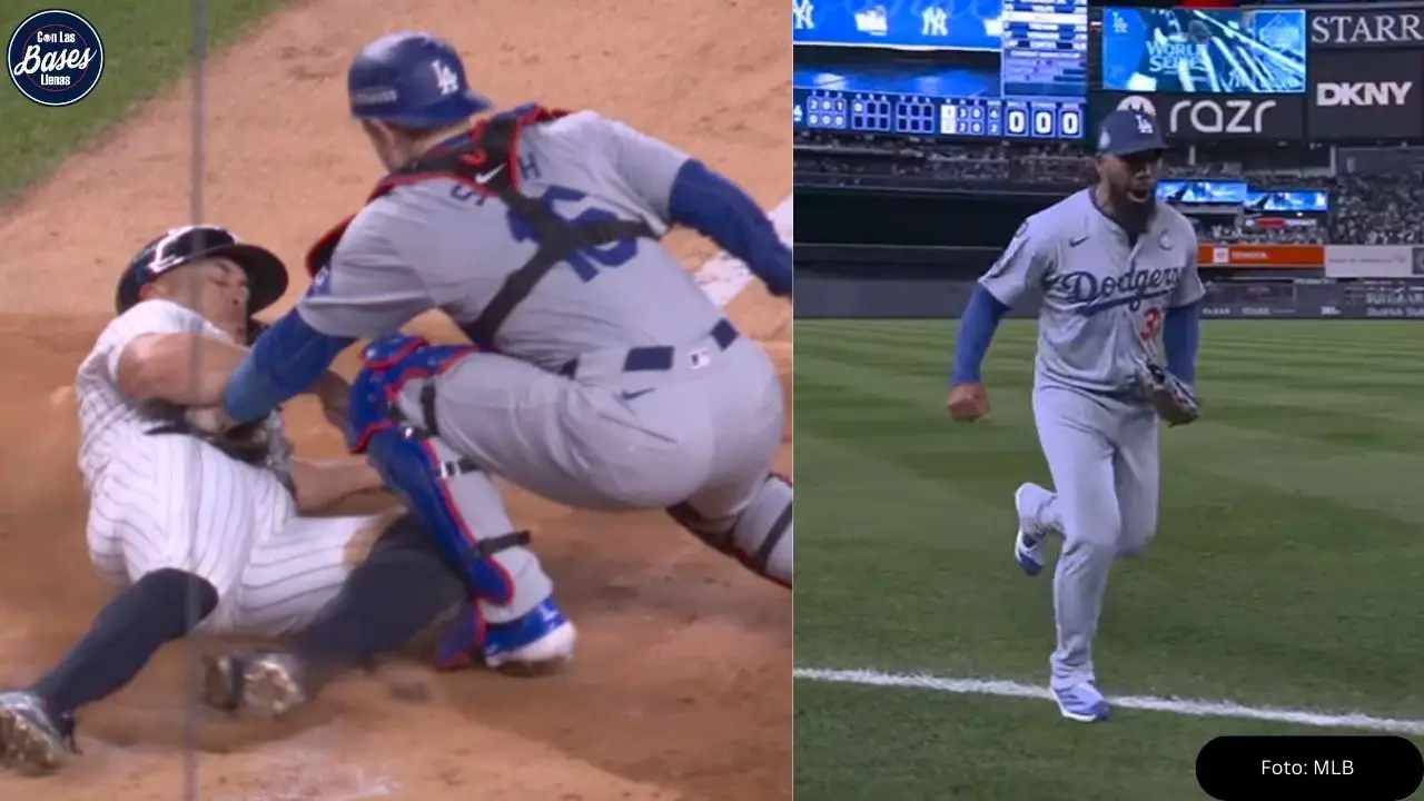 Teoscar Hernández, outfielder dominicano de los Dodgers, saca su brazo para evitar una carrera y pone out en home a Giancarlo Stanton.